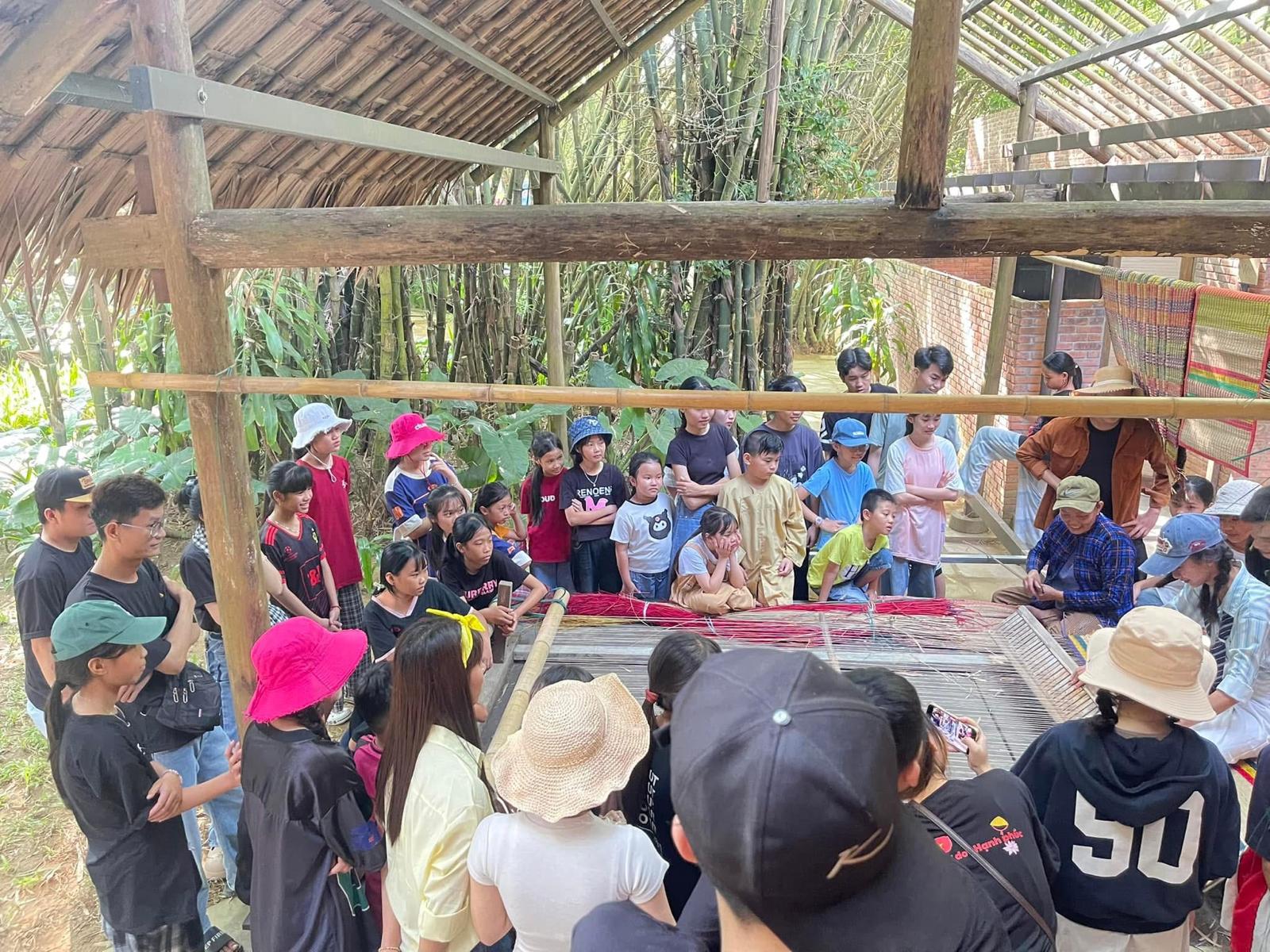 Visitors watching a traditional mat-weaving demonstration