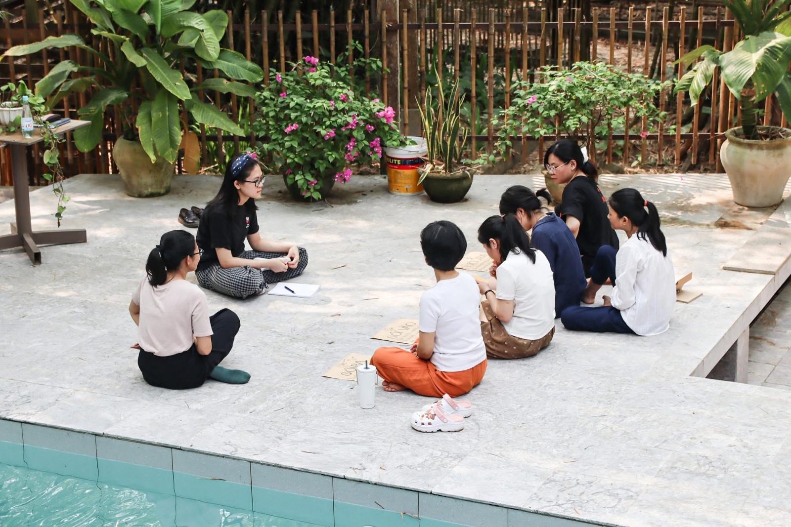 Poolside discussion circle with guests