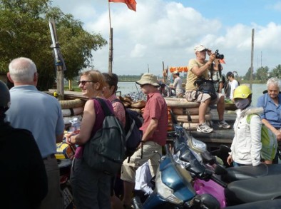 Guests crossing the bamboo bridge into Triêm Tây