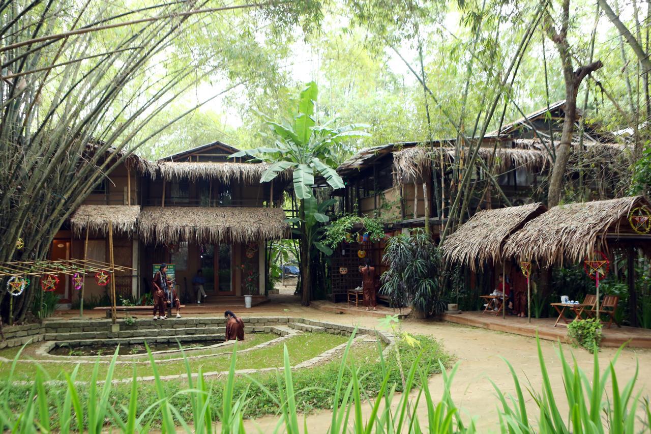 Village courtyard with bamboo houses