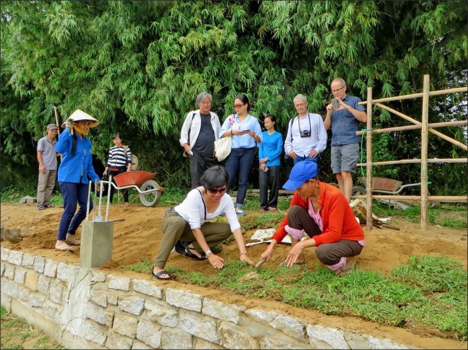 Restored riverbank with planted vegetation and stone wall