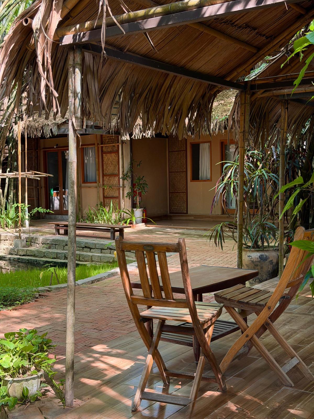 Thatched bungalow terrace with garden seating