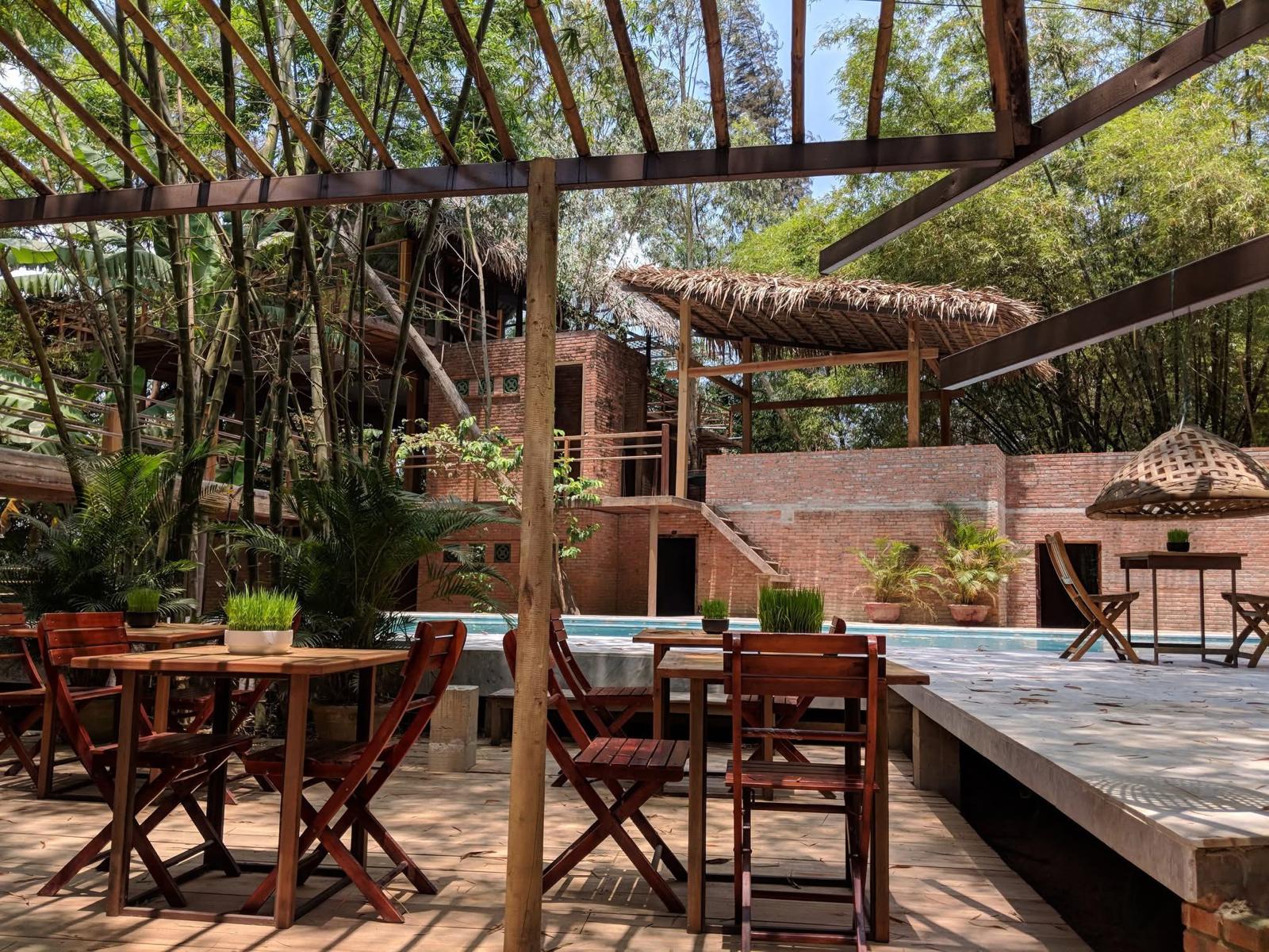 Poolside dining tables in the brick courtyard