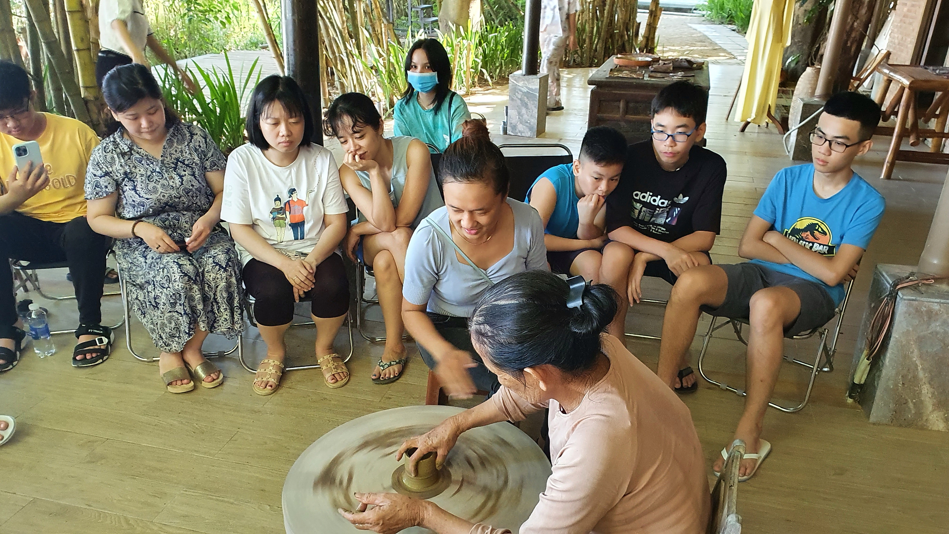 Pottery wheel demonstration with attentive audience