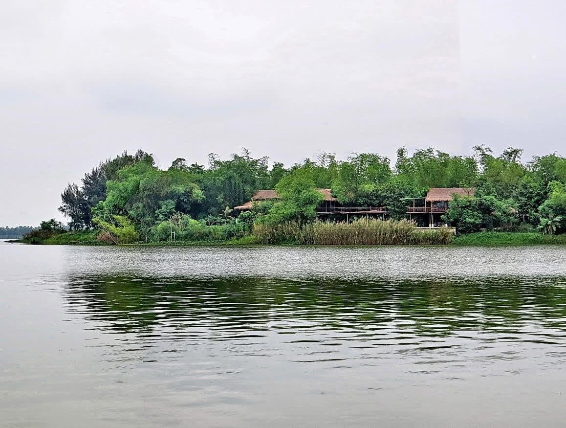 The eco-village seen from across the river