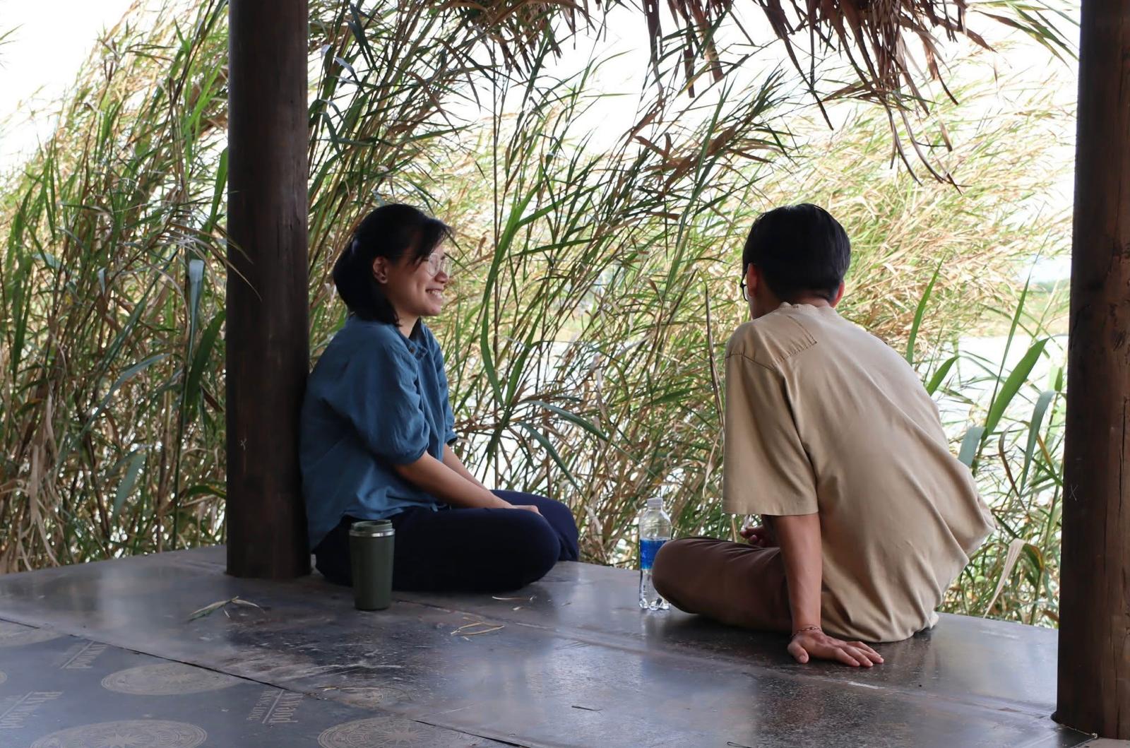 Remote worker at a bamboo desk overlooking gardens