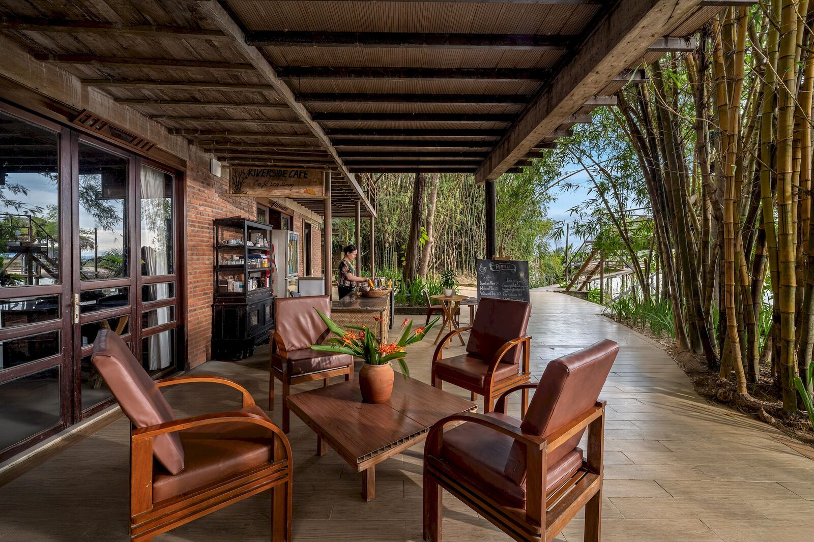 Café lounge with leather armchairs by the bamboo
