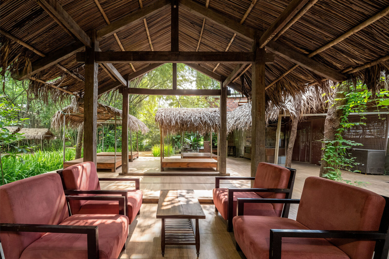 Open pavilion with armchairs and garden views