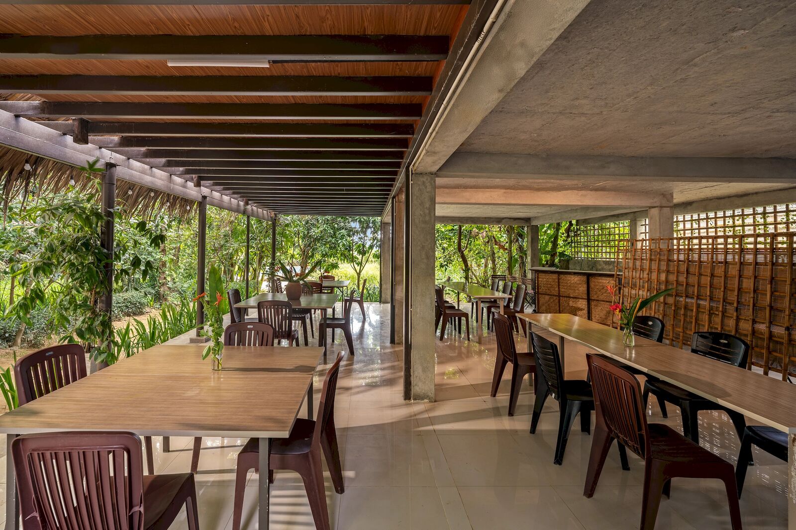 Long dining tables beside the bamboo screens