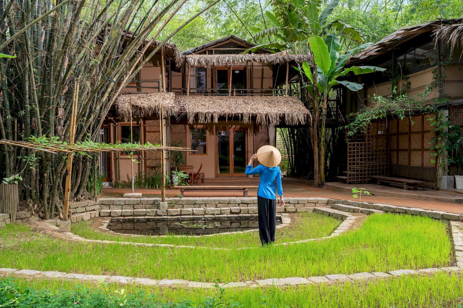 A member of the team in ao dai by the rice courtyard