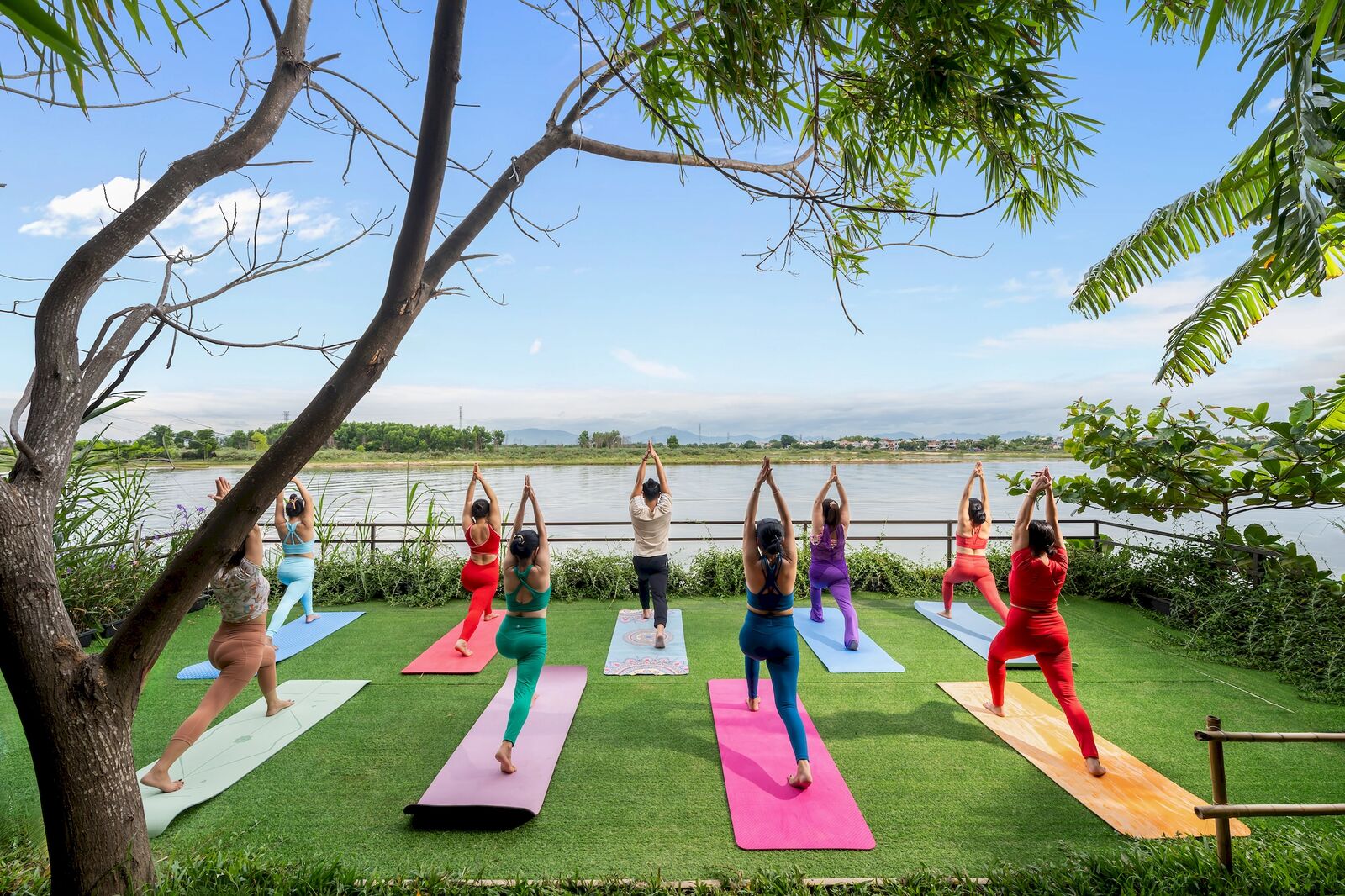 Morning yoga on the riverside lawn