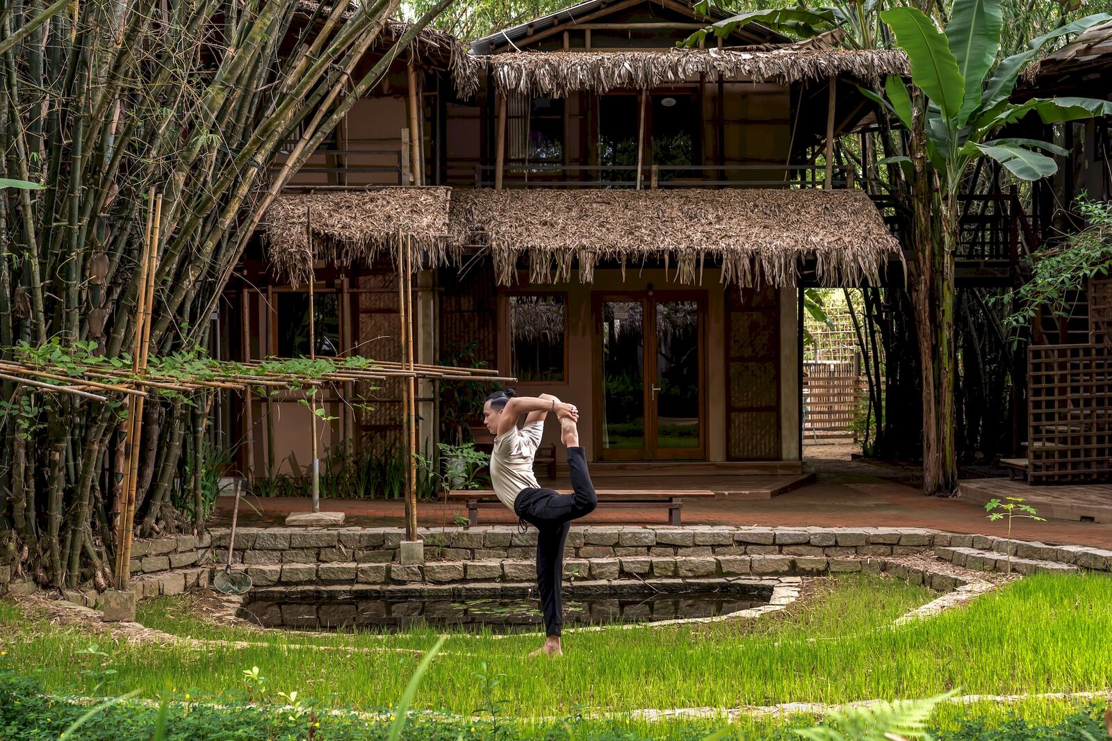 Dancer pose beside the bamboo house